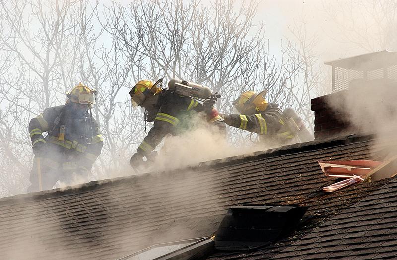 Members of the WHFD ventilate the roof on Sherwood Drive.
