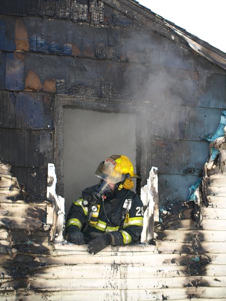 Brian Holdredge assisting in overhaul at a recent structure fire.