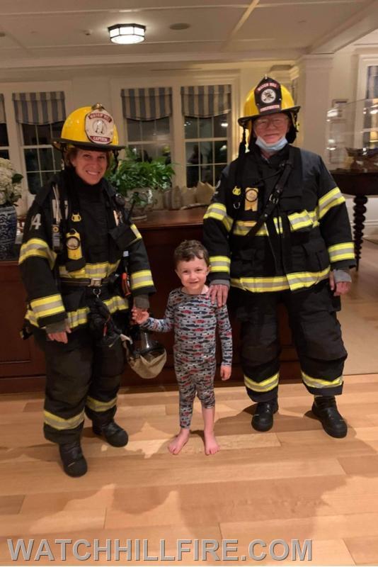 Captain Jane Perkins and Firefighter Dennis Evans with a young visitor from Maryland who apparently was enjoying being awake in the middle of the night!