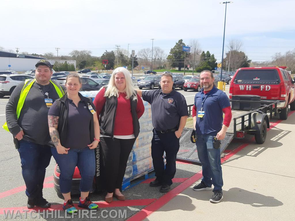 Walmart Manager Jessica stands with her staff and Fire Marshal Chris Moore prior to loading their donation onto the WHFD trailer this week. 