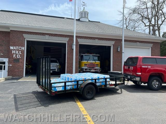 Westerly Walmart's donation of a pallet of bottled drinking water is seen on the flatbed trailer behind Truck 100 at the Fire Station this week. 