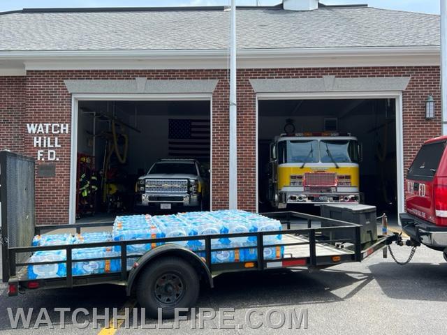 Westerly Walmart's donation of a pallet of bottled drinking water is seen on the flatbed trailer behind Truck 100 at the Fire Station this week. 