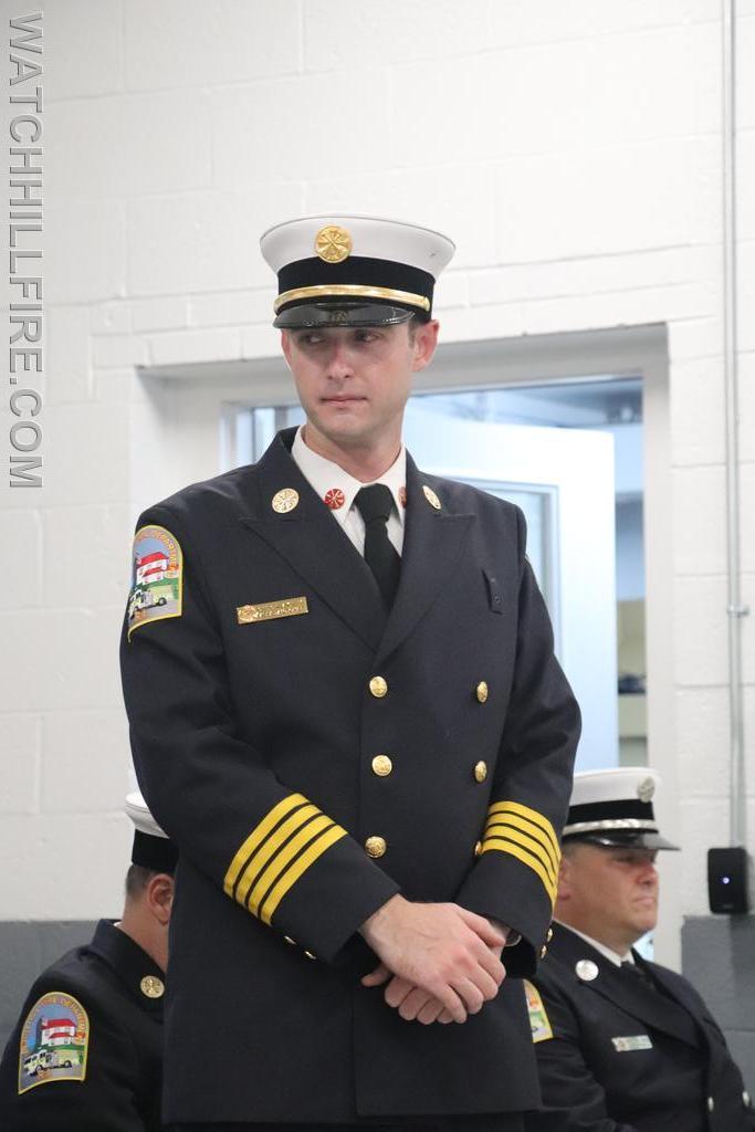 Assistant Chief Christopher Koretski listens while Past Chief Scott Harold delivers his bio
