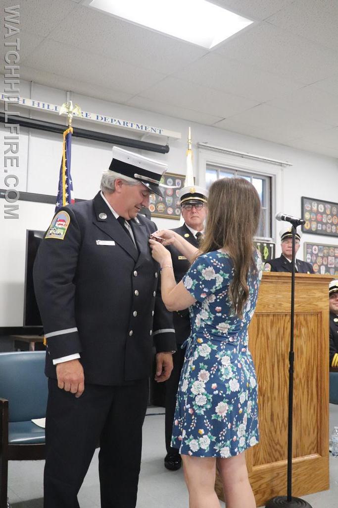 Lieutenant Mello's badge is pinned by his wife Sherry
