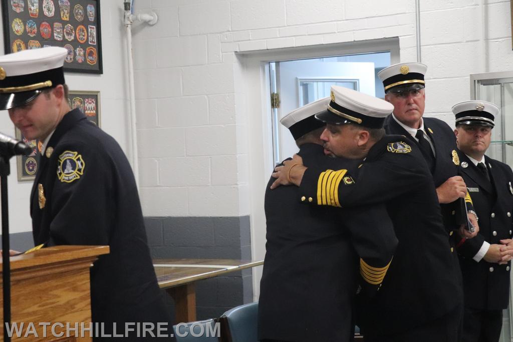 Chief Reall and Chief Simmons embrace