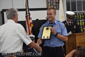 Lieutenant Murphy get his award from FF Majeika